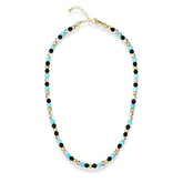 Close-up of turquoise, clear quartz, and onyx beads in men's necklace
